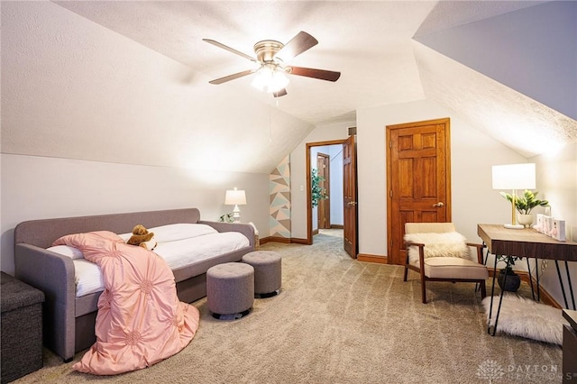 carpeted bedroom featuring a textured ceiling, vaulted ceiling, and ceiling fan