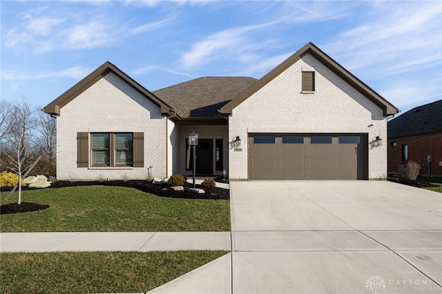 view of front of house with a garage and a front lawn