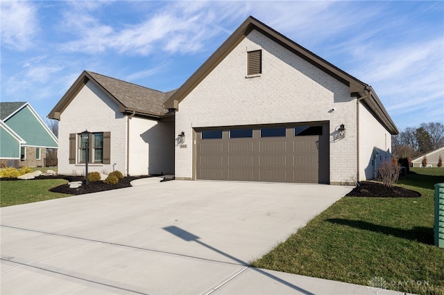 view of front of property with a front lawn and a garage