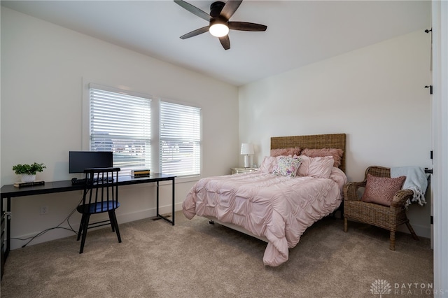 bedroom featuring light carpet and ceiling fan