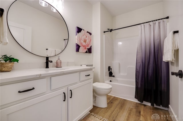 full bathroom featuring vanity, toilet, wood-type flooring, and shower / bathtub combination with curtain