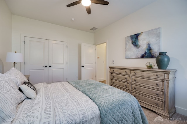 bedroom featuring ceiling fan, a closet, and carpet