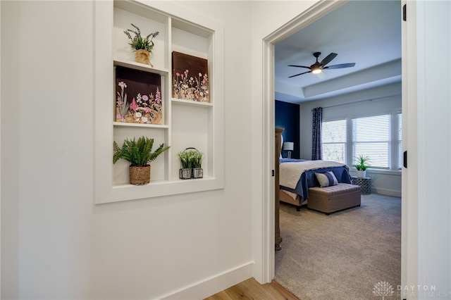 hallway with light hardwood / wood-style floors