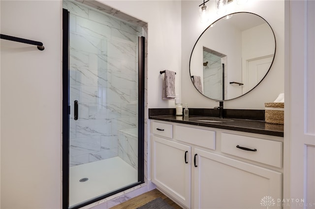 bathroom featuring vanity and a shower with shower door