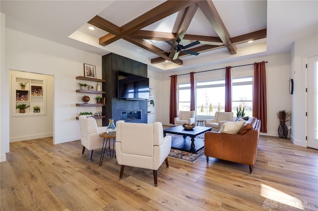 living room with light hardwood / wood-style floors and coffered ceiling