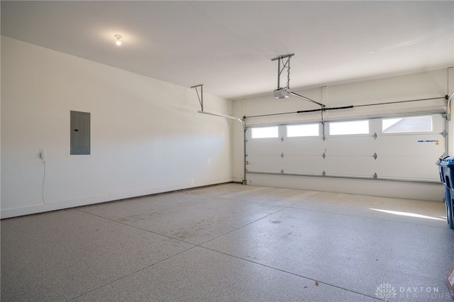 garage with electric panel and a garage door opener