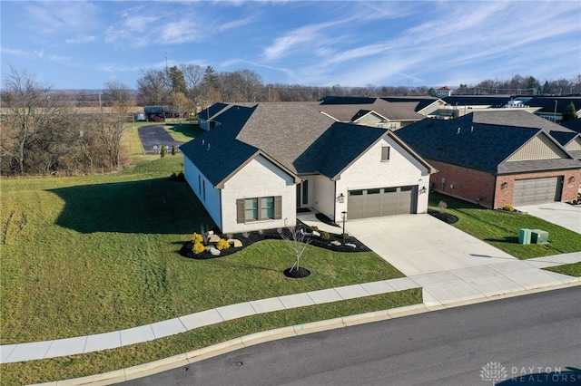 view of front of home with a garage and a front lawn