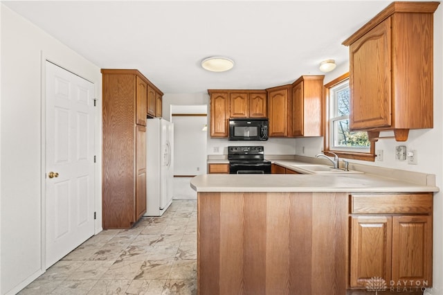 kitchen featuring kitchen peninsula, sink, and black appliances