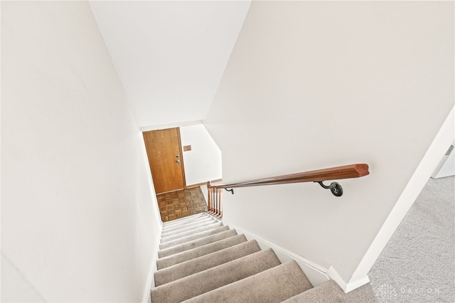 stairs with vaulted ceiling and parquet flooring