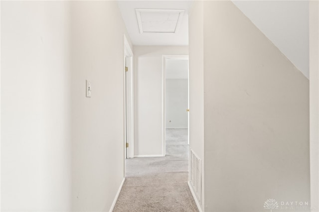 hall featuring light colored carpet