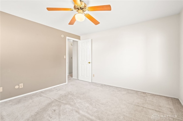 empty room featuring light colored carpet and ceiling fan