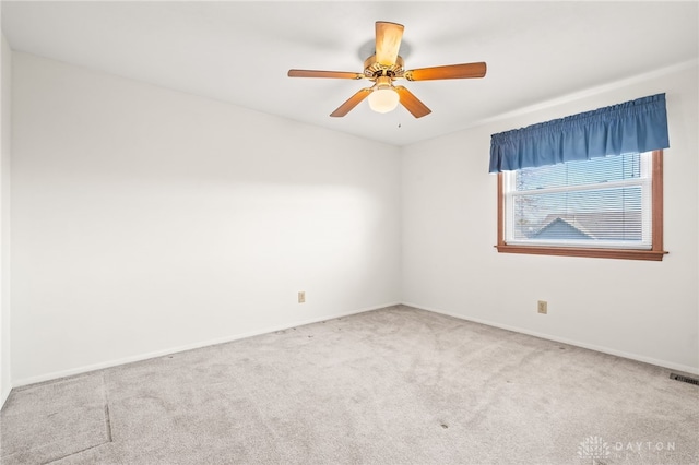 empty room with ceiling fan and carpet