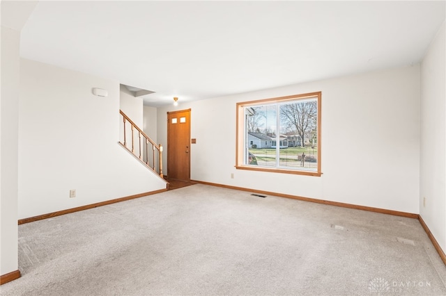 spare room featuring light colored carpet