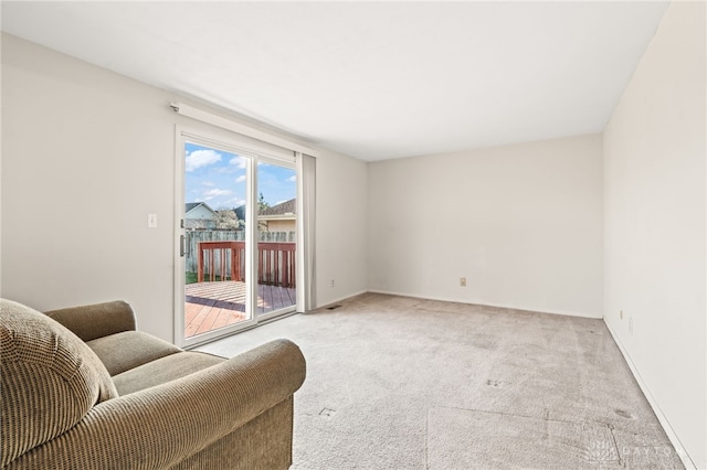 sitting room featuring light carpet