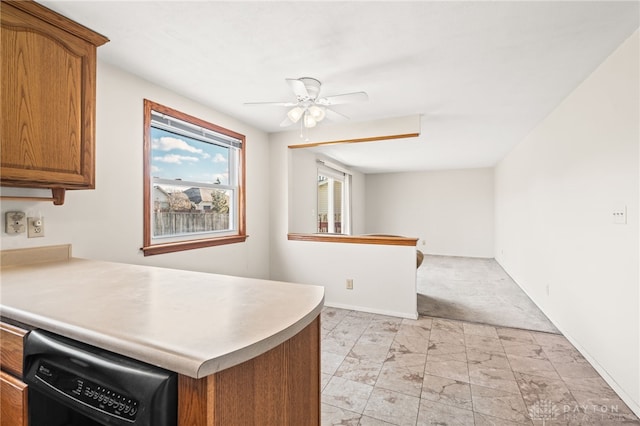 kitchen featuring kitchen peninsula, ceiling fan, and black dishwasher