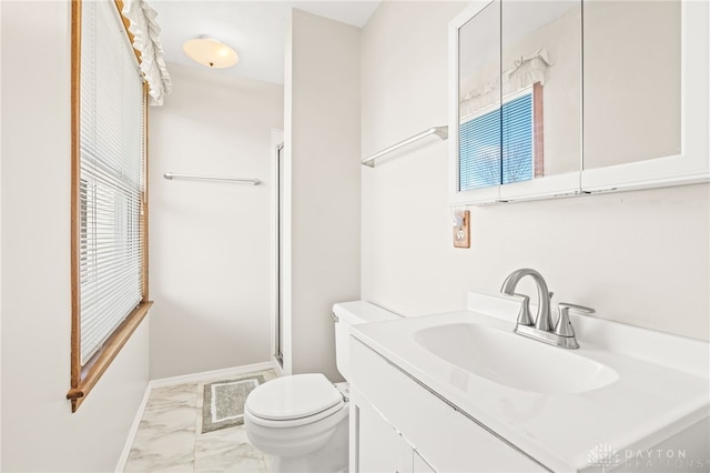 bathroom with plenty of natural light, toilet, a shower with door, and vanity