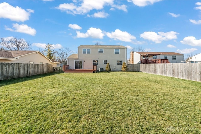 back of property with central AC, a yard, and a deck