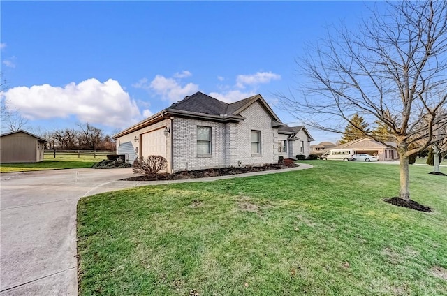 view of side of home featuring a garage and a yard