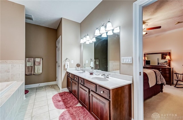 bathroom with ceiling fan, tiled bath, tile patterned floors, and vanity