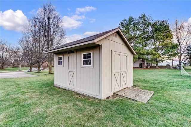 view of outdoor structure with a lawn