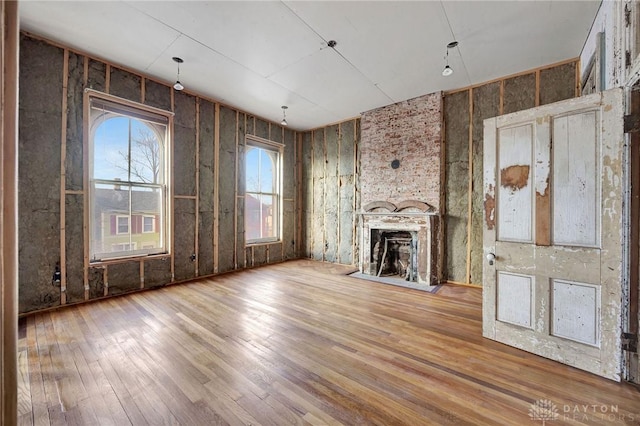 unfurnished living room featuring a fireplace and hardwood / wood-style flooring