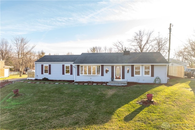 single story home featuring a front lawn