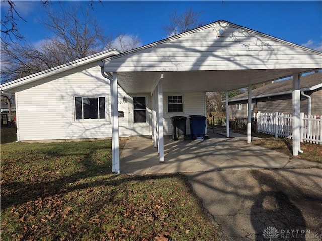 exterior space with a front lawn and a carport