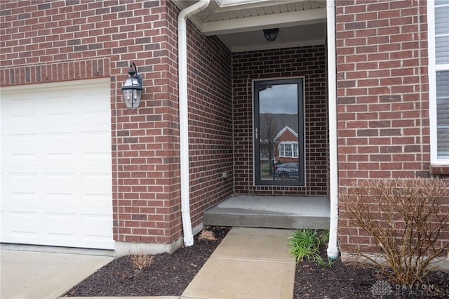 doorway to property with a garage