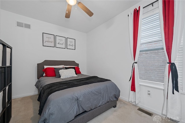 bedroom featuring ceiling fan and light carpet