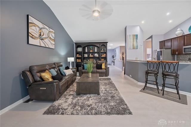 living room featuring ceiling fan and lofted ceiling