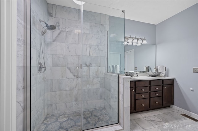 bathroom with vanity and a shower with shower door