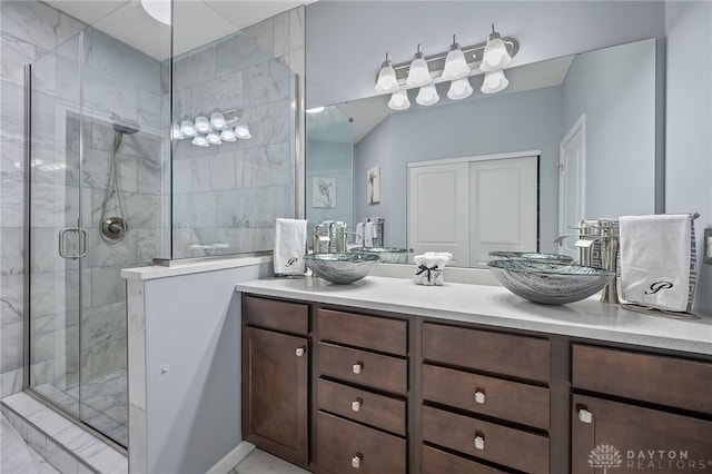 bathroom featuring vanity and an enclosed shower