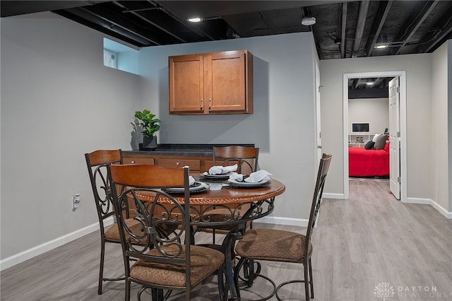 dining space with light hardwood / wood-style flooring