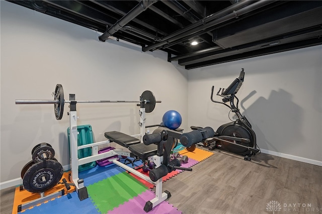 workout area with wood-type flooring