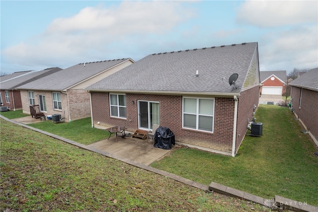 rear view of property featuring a yard, central AC unit, and a patio area