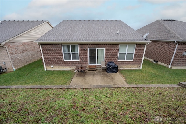 rear view of house with a patio area and a lawn