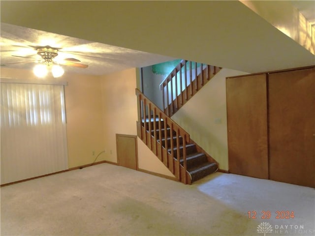 interior space featuring carpet flooring and ceiling fan