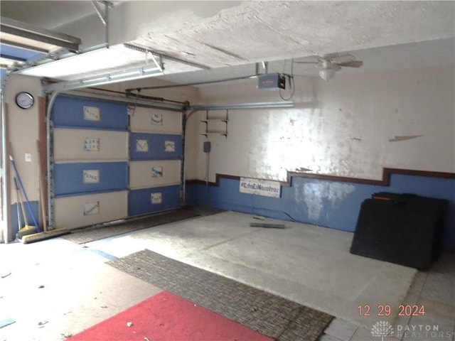 garage featuring a garage door opener and ceiling fan