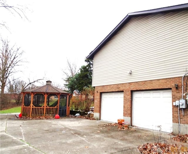 view of side of home featuring a gazebo