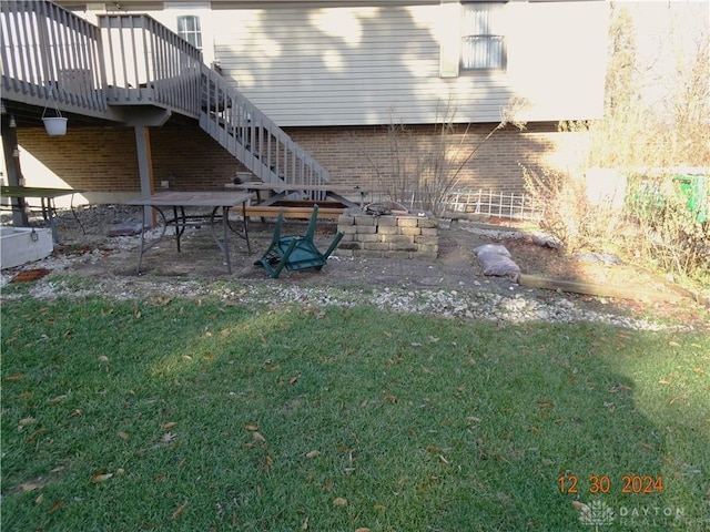 view of yard with a deck, an outdoor fire pit, and a patio area