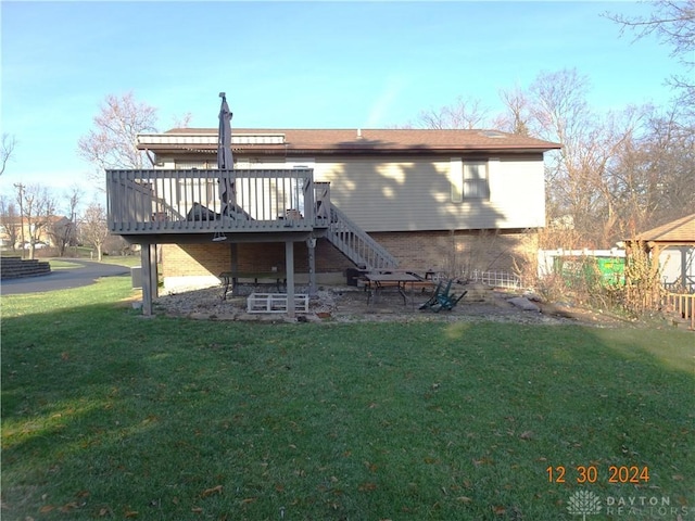 back of property featuring a deck and a yard