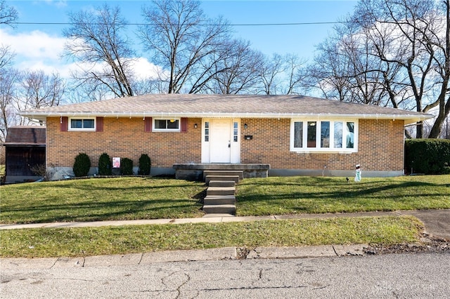 ranch-style house with a front lawn and brick siding