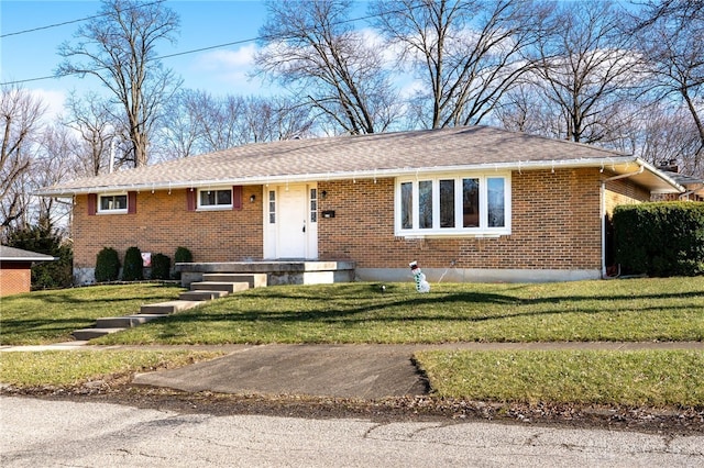 ranch-style house featuring a front yard and brick siding