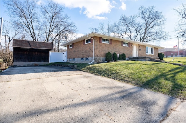 view of front of home with a front yard and brick siding