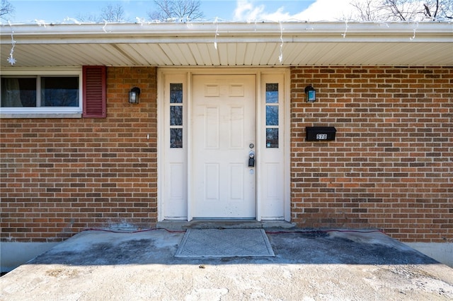 property entrance featuring brick siding