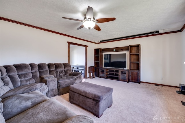 living area featuring a textured ceiling, ceiling fan, light colored carpet, baseboards, and crown molding