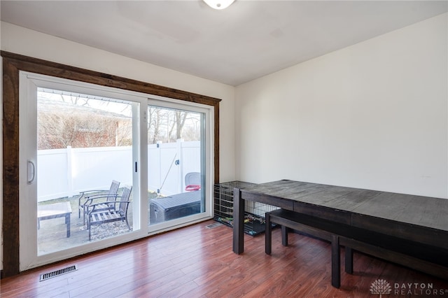 dining area featuring wood finished floors and visible vents