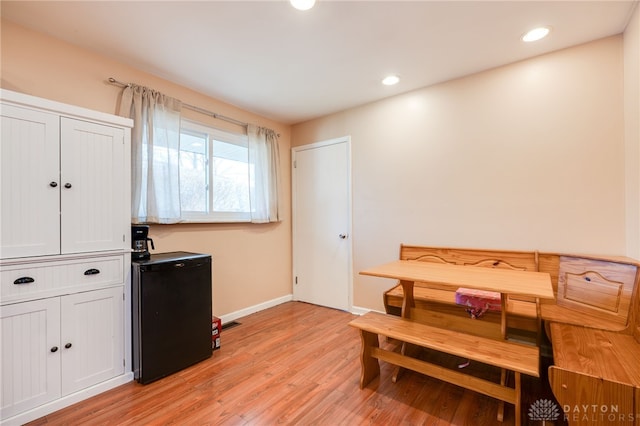 dining area featuring light wood finished floors, baseboards, and recessed lighting