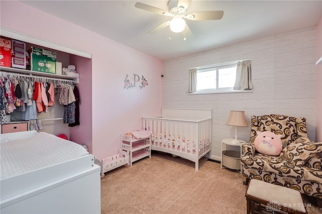 bedroom featuring light carpet, a closet, and a ceiling fan