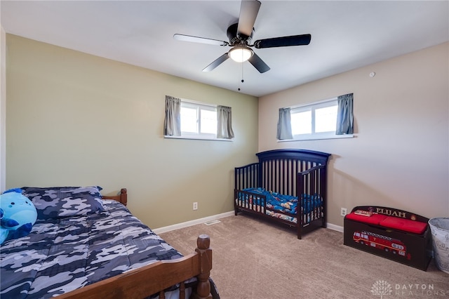 bedroom with carpet floors, ceiling fan, multiple windows, and baseboards